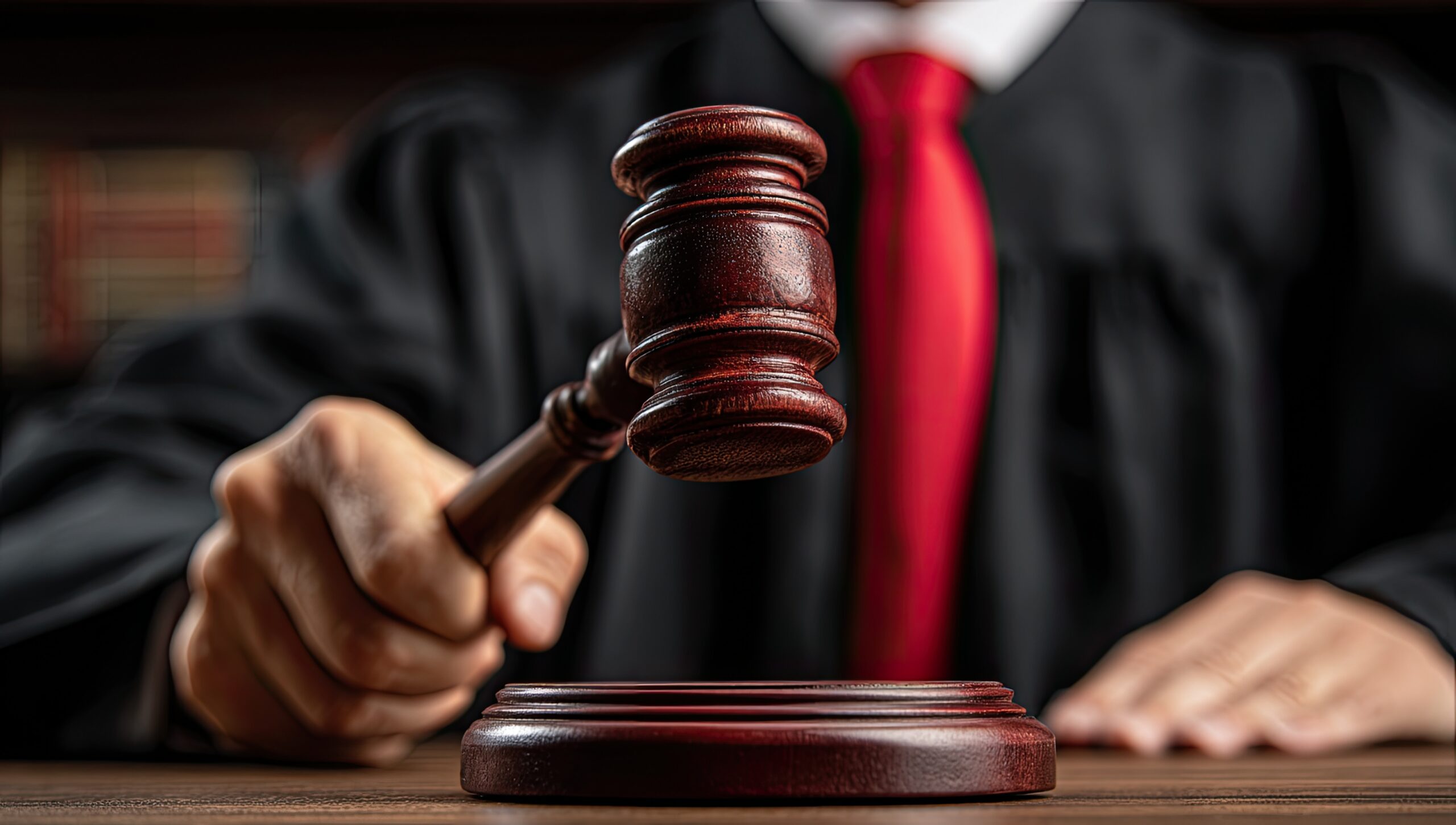 Close-up of judge banging wooden gavel